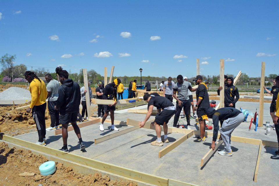 University of Missouri Football team members start to frame up a wall April 21 of a Show Me Central Habitat for Humanity home at the organization's Boone Prairie Subdivision in Columbia.