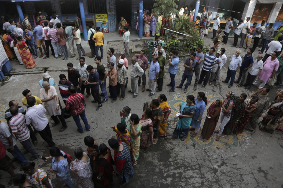 Indian voters stand in queues to cast their votes at Baksara in Howrah, India, Monday, May 6, 2019. With 900 million of India's 1.3 billion people registered to vote, the Indian national election is the world's largest democratic exercise. (AP Photo/Bikas Das)