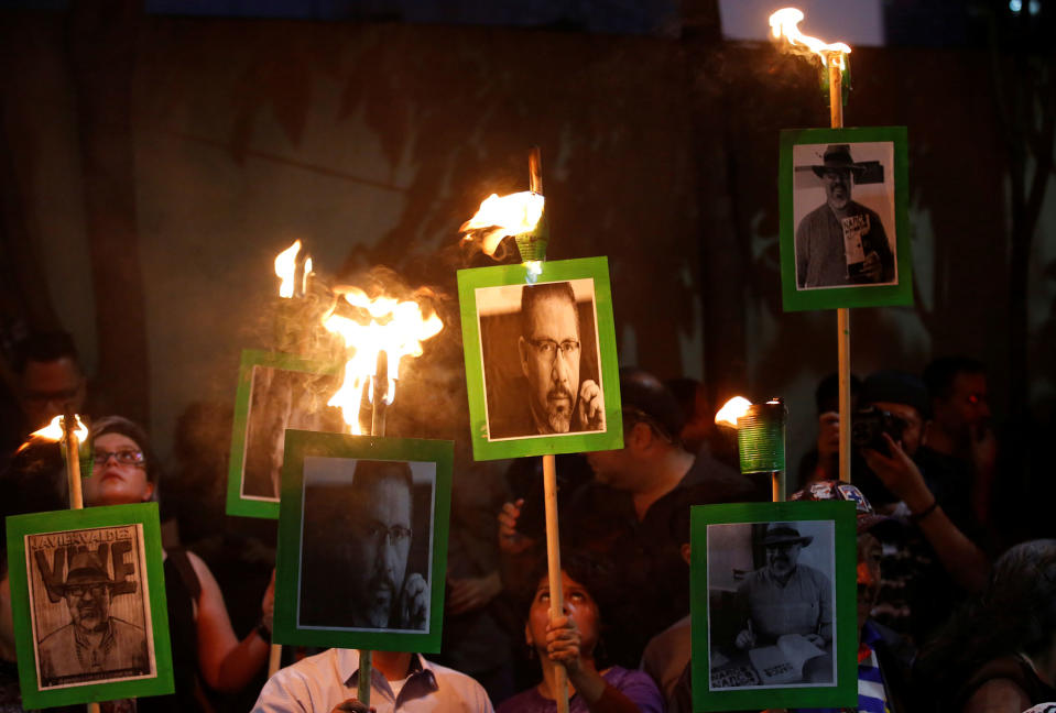 <p>Journalists and demonstrators hold up pictures of journalist Javier Valdez during a demonstration against his killing and for other journalists who were killed, at the Interior Ministry building in Mexico City, Mexico on May 16, 2017. (Henry Romero/Reuters) </p>