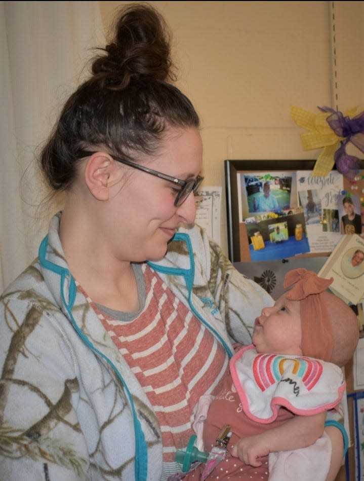 Jaisline Wilson, 19, of Anderson, South Carolina, holds her baby Zhavia, the youngest of six family generations to gather in Kentucky earlier this year.