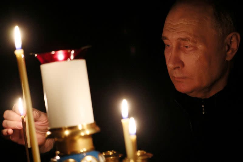 FILE PHOTO: Russian President Putin lights a candle in memory of the victims of the Crocus City Hall attack, in Moscow Region
