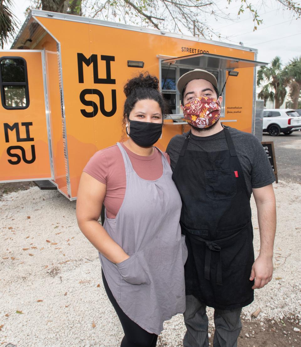 Owners Hylene and Alden Garcia stand outside their MI SU food truck at 528 West Garden Street in downtown Pensacola on Thursday, Jan. 21, 2021.