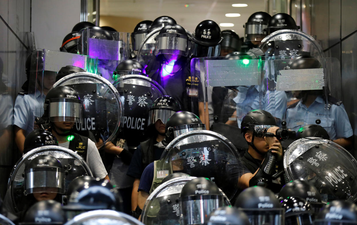 Riot police stand guard outside Mong Kok police station during the "Reclaim Hung Hom and To Kwa Wan, Restore Tranquility to Our Homeland" demonstration against the extradition bill, Hong Kong, China August 17, 2019. REUTERS/Kim Hong-Ji