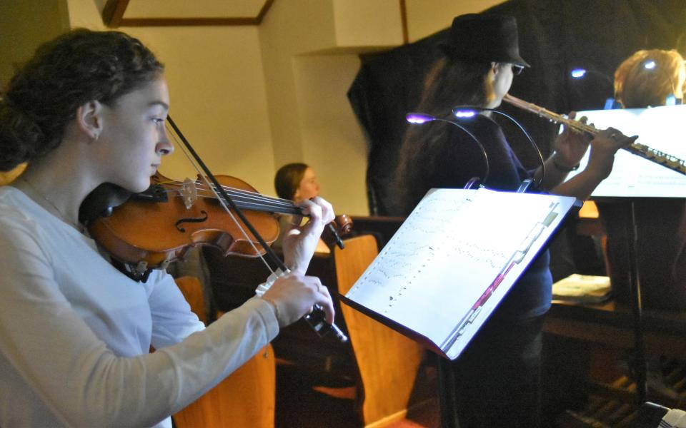 Chloe Birkenfeld, whose late grandfather, Herman, was renowned for his skill on the fiddle, graces the Nazareth Christmas Pageant with her skill on the violin. Here she plays in company with Angela Fulkerson, in the background.