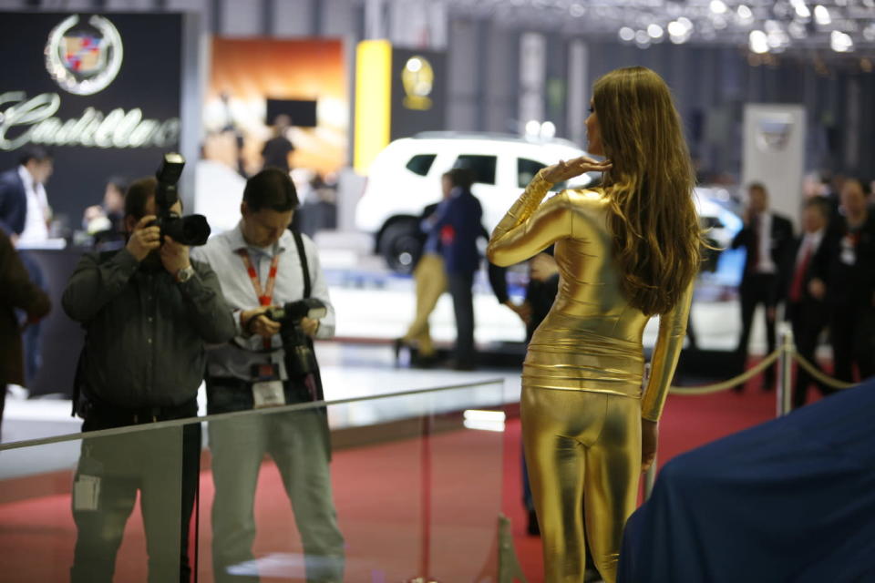 A model poses for photographers before the unveiling of the Bertone Jet 2+2 at the 2013 Geneva Motor Show.