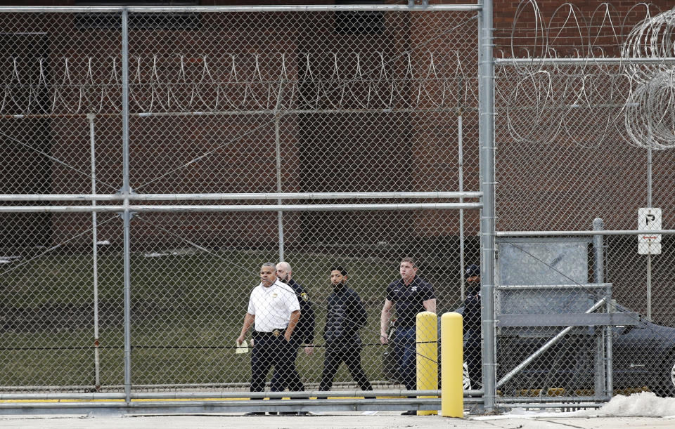 "Empire" actor Jussie Smollett, center, is escorted to a gate as he leaves Cook County jail following his release, Thursday, Feb. 21, 2019, in Chicago. Smollett was charged with disorderly conduct and filling a false police report when he said he was attacked in downtown Chicago by two men who hurled racist and anti-gay slurs and looped a rope around his neck, a police official said. (AP Photo/Kamil Krzaczynski)