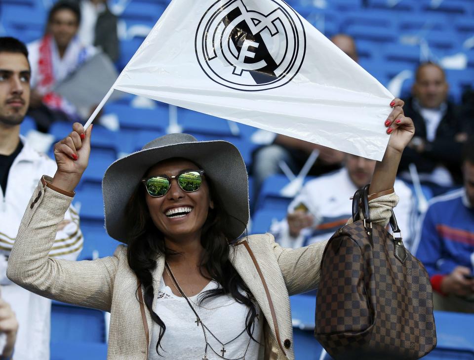 A Real Madrid fan holds her flag ahead of their Champions League semi-final first leg soccer match against Bayern Munich at Santiago Bernabeu stadium in Madrid