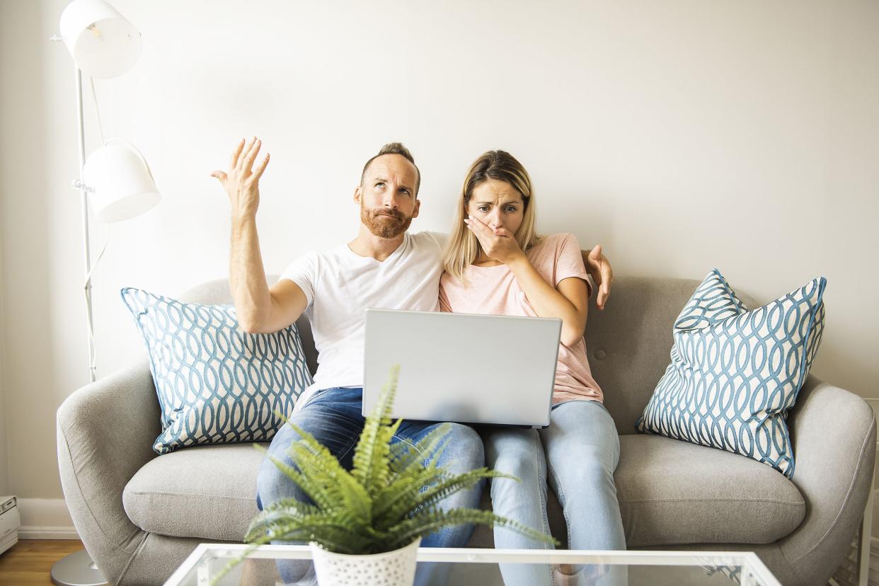 young man with his girlfriend on laptop at home indoor