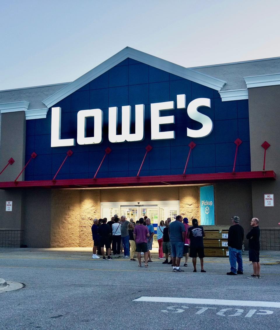 Residents gathered outside a Lowe's store on Friday, Sept. 30, 2022, to gather supplies to begin cleaning up their homes after Hurricane Ian in Englewood, Florida.