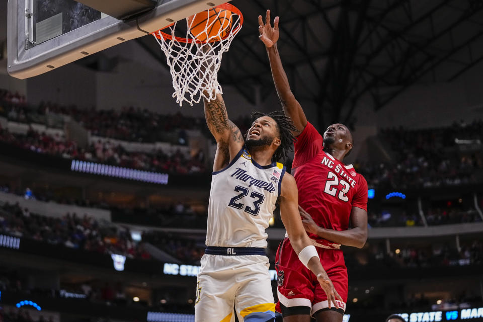 Marquette's David Joplin, left, dunks in front of North Carolina State's Mohamed Diarra during the second half of a Sweet 16 college basketball game in the NCAA Tournament in Dallas, Friday, March 29, 2024. (AP Photo/Tony Gutierrez)