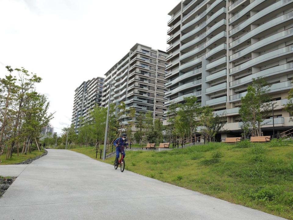 A security guard rides a bike through the Tokyo Olympic village