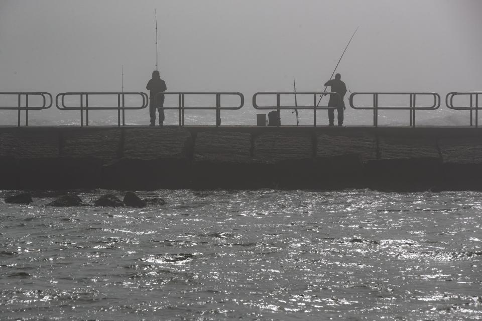 People fish on the south Packery Channel jetty on Nov. 29, 2022 in Corpus Christi, Texas.