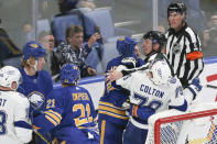 Buffalo Sabres center Zemgus Girgensons (28) and Tampa Bay Lightning left wing Ross Colton (79) shove each other as linesman Tim Nowak tries to intervene during the third period of an NHL hockey game Monday, Oct. 25, 2021, in Buffalo, N.Y. (AP Photo/Joshua Bessex)