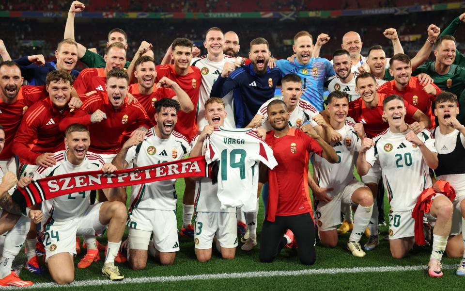 Players of Hungary pose for a photo as Andras Schafer holds up the shirt of Barnabas Varga