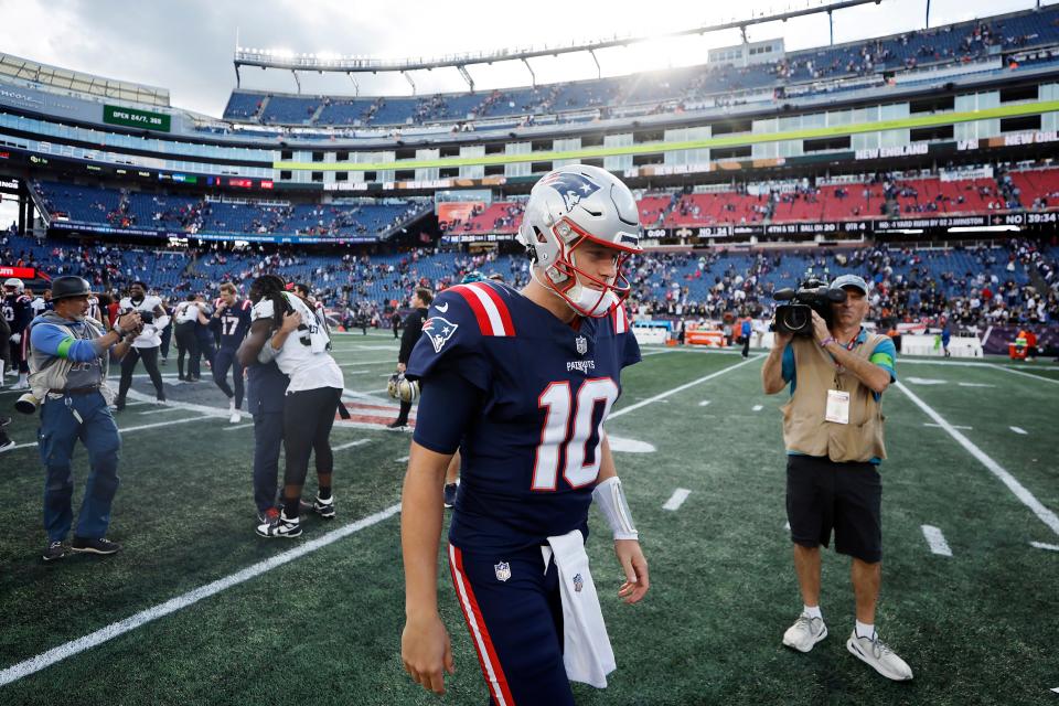 FOXBOROUGH, MASSACHUSETTS - OCTOBER 08: Mac Jones #10 of the New England Patriots walks off the field after his team's 34-0 loss against the New Orleans Saints at Gillette Stadium on October 08, 2023 in Foxborough, Massachusetts. (Photo by Winslow Townson/Getty Images)