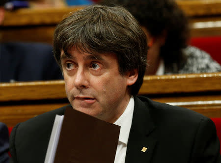 Catalan President Carles Puigdemont looks on before addressing deputies in the chamber at the Catalonian regional parliament in Barcelona, Spain, October 10, 2017. REUTERS/Albert Gea