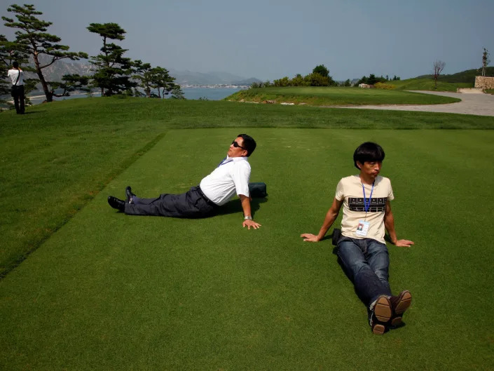 Visitors enjoy the manicured lawn at the South Korean-owned golf course at the Mount Kumgang resort, also known as Diamond Mountain, in North Korea on Sept. 1, 2011.