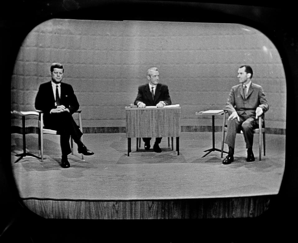 Democrat Sen. John Kennedy, left and Republican Richard Nixon, right, as they debated campaign issues at a Chicago television studio on Sept. 26, 1960. Moderator Howard K. Smith is at desk in center.