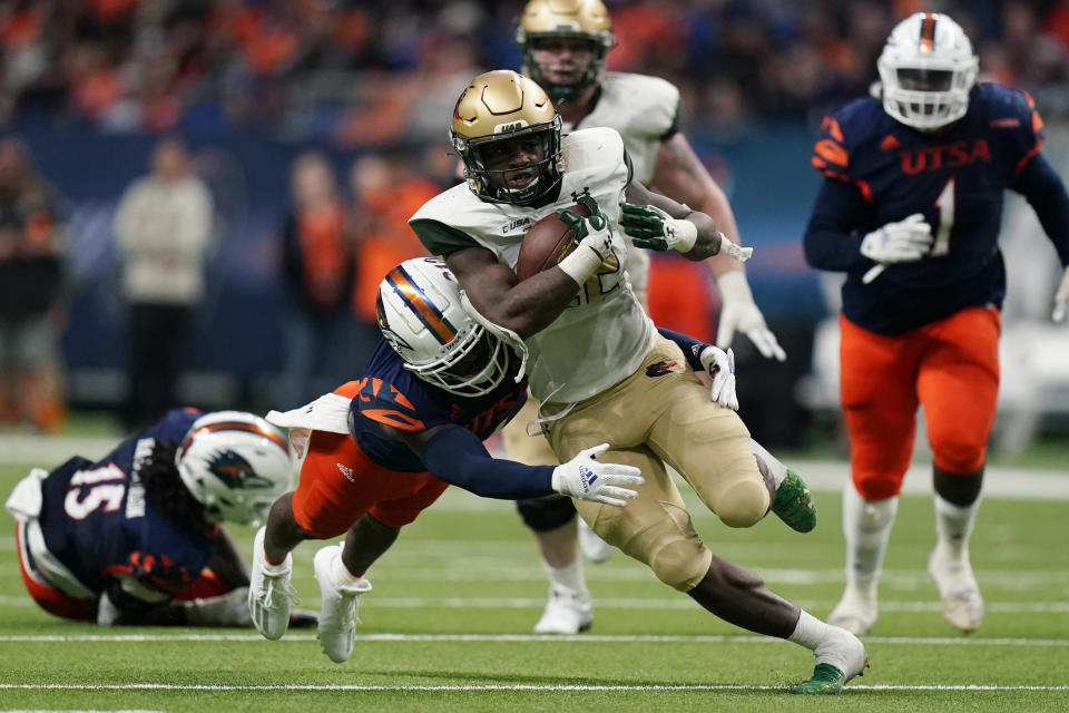 UAB running back DeWayne McBride (22) is hit by UTSA safety Antonio Parks (4) on a run during the first half of an NCAA college football game, Saturday, Nov. 20, 2021, in San Antonio. (AP Photo/Eric Gay)