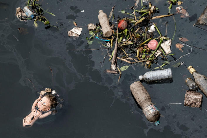 <p>View of floating debris carried by the tide and caught by the “eco-barrier” before entering Guanabara Bay, at the mouth of Meriti river in Duque de Caxias, next to Rio de Janeiro, Brazil, on July 20, 2016. (Yasuyoshi Chiba/AFP/Getty Images)