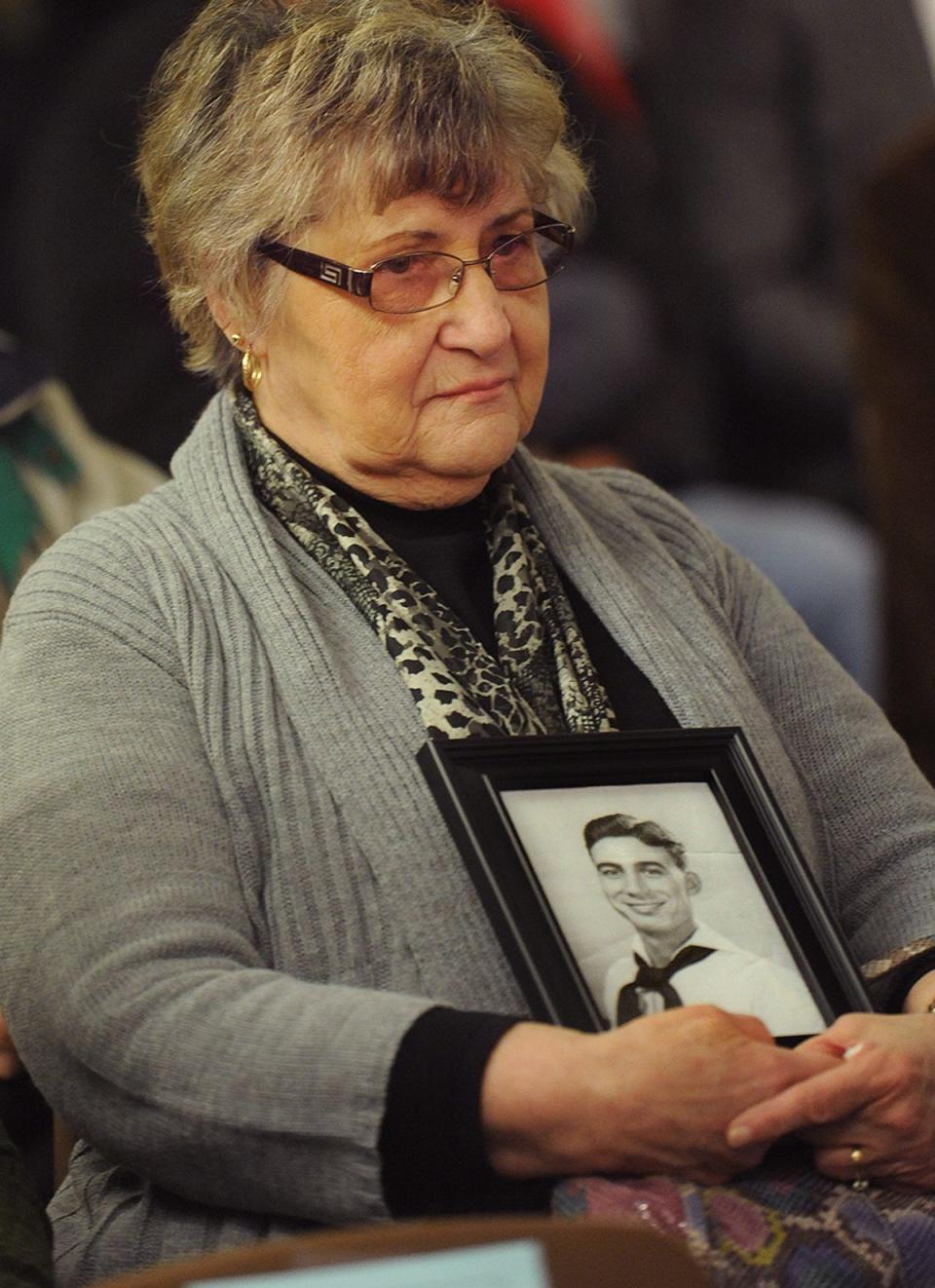 During a Pearl Harbor Day observance in 2018, Shirley Saucier holds a picture of her uncle, Charles Braga, a Fall Riverite killed in the December 1941 attack.