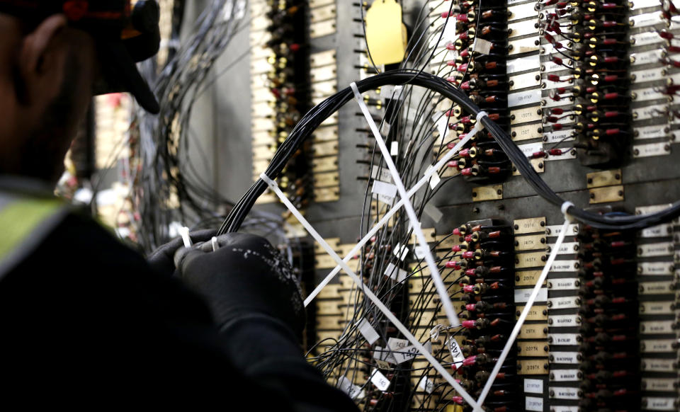 Troy Glover works on an electrical switchboard panel which operates train service on the Port Authority of New York and New Jersey's PATH system after it was damaged by Superstorm Sandy Tuesday, Nov. 27, 2012, in Hoboken, N.J. While parts of the trans-Hudson service have gradually resumed operation since the storm, the Hoboken station has been closed, leaving thousands of commuters to seek alternatives. (AP Photo/Julio Cortez)