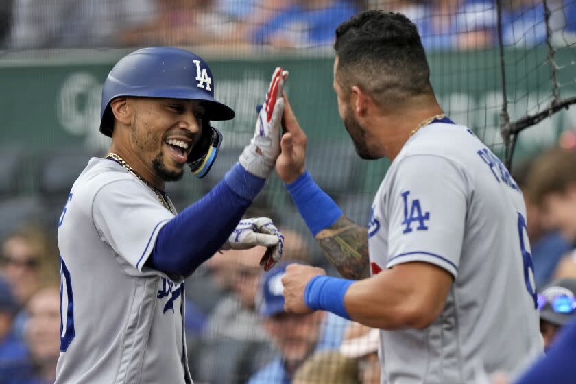 The Dodgers' Mookie Betts celebrates with David Peralta after hitting a solo home run against the Royals