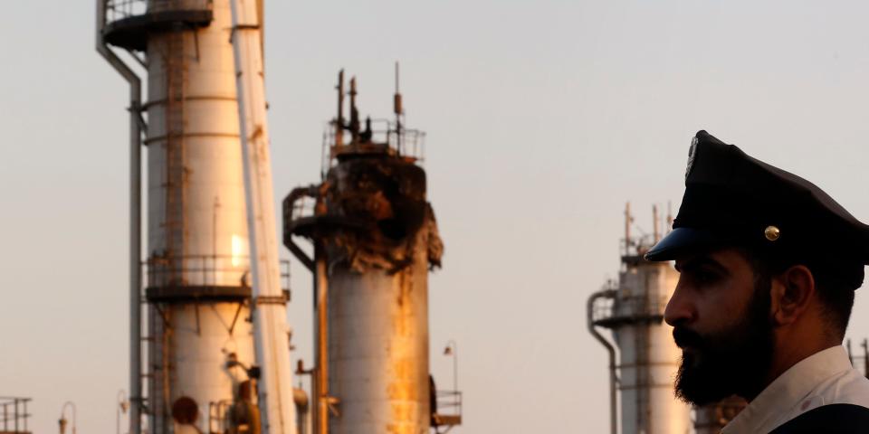 During a trip organized by Saudi information ministry, a security guarder stands alert in front of Aramco's oil processing facility after the recent Sept. 14 attack on Aramco's oil processing facility in Abqaiq, near Dammam in the Kingdom's Eastern Province, Friday, Sept. 20, 2019. Saudi Arabia allowed journalists access Friday to the site of a missile-and-drone attack on a facility at the heart of the kingdom's oil industry, an assault that disrupted global energy supplies and further raised tensions between the U.S. and Iran. (AP Photo/Amr Nabil)