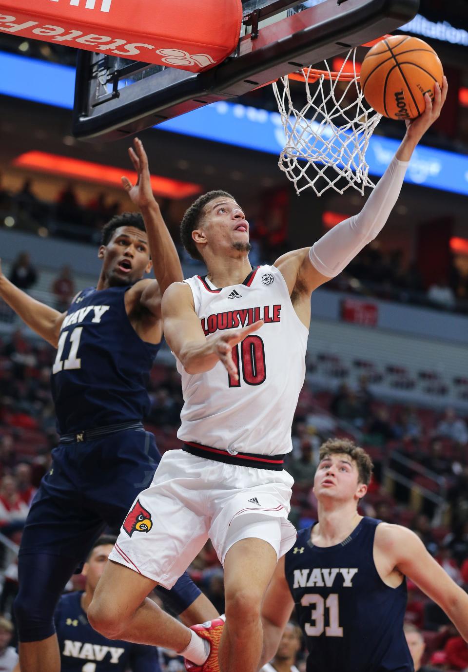 U of L's Samuell Williamson (10) hits a reverse layup against Navy during their game at the Yum Center in Louisville, Ky. on Nov. 15, 2021.
