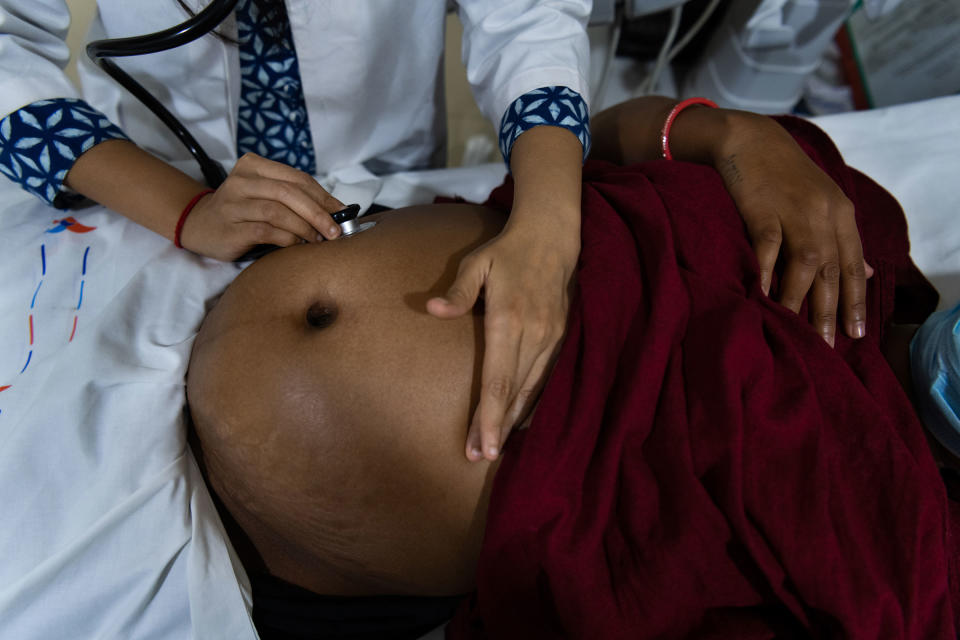 Kajal Vasava, 24, undergoes a checkup at Akanksha, seven months into her pregnancy. A first-time surrogate, Vasava has brought her 3-year-old daughter to stay with her at the clinic for the entire duration of her pregnancy. She turned to surrogacy after financial difficulties during India's COVID-19 lockdown.<span class="copyright">Smita Sharma for TIME</span>