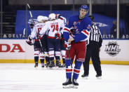 New York Rangers' Kaapo Kakko (24) skates back to the bench as the Washington Capitals celebrate a second-period goal by Nic Dowd during an NHL hockey game Wednesday, May 5, 2021, in New York. (Bruce Bennett/Pool Photo via AP)