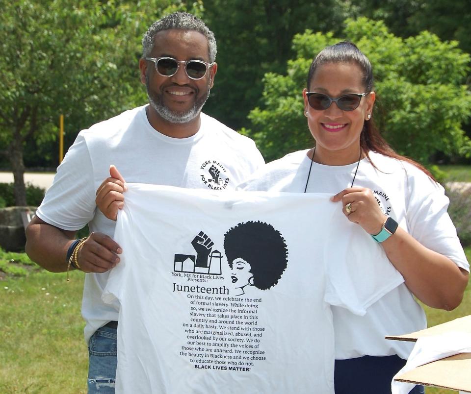 Grecia and Jose Caraballo hold up the shirt designed by their daughter, Jailynn Caraballo, to commemorate Juneteenth. They were among those who gathered Saturday, June 19, 2021, for a Juneteenth walk-a-thon in York, Maine.