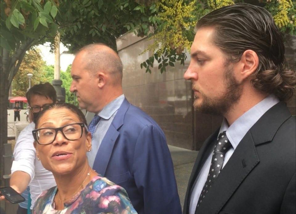 Dodgers pitcher Trevor Bauer appeared with his legal team outside an LA courtroom after his restraining order was rescinded on Thursday.