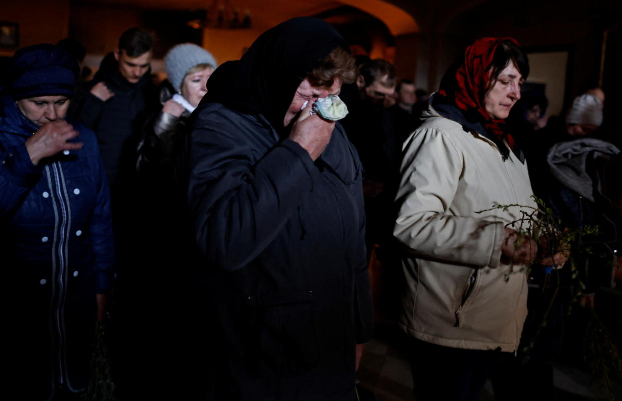 Galina Bondar, who says her son was killed by Russian troops, weeps during Palm Sunday mass.