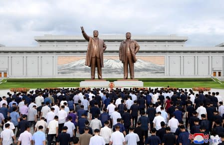 People visit the statues of former North Korean leaders Kim Il Sung and Kim Jong Il in North Korea