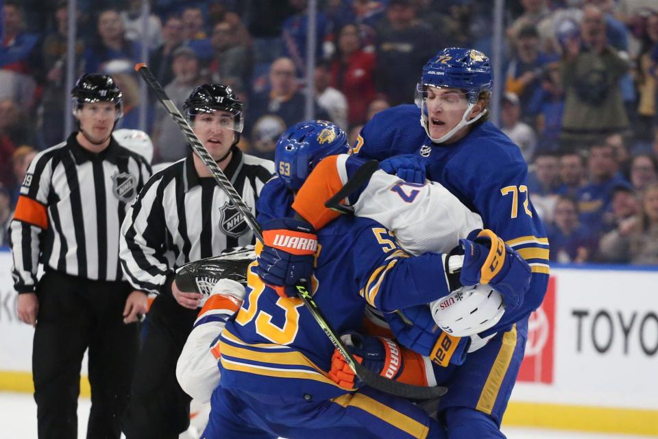 Buffalo Sabres right wing Tage Thompson (72) tries to pull New York Islanders left wing Matt Martin (17) off of left wing Jeff Skinner (53) during the third period of an NHL hockey game on Saturday, April 23, 2022, in Buffalo, N.Y. (AP Photo/Joshua Bessex)