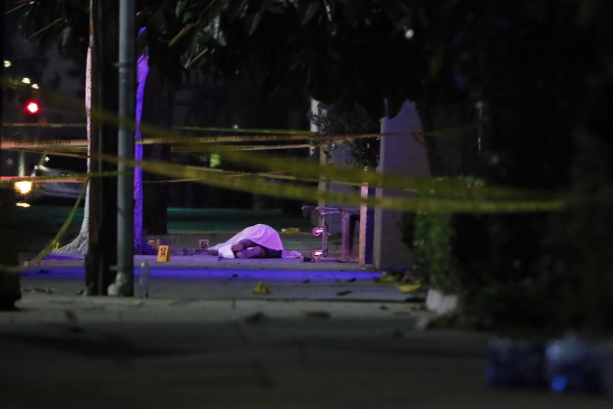 A suspect's body lies in the street after a shooting that left two officers dead on Tuesday, June 14, 2022, in El Monte, California.