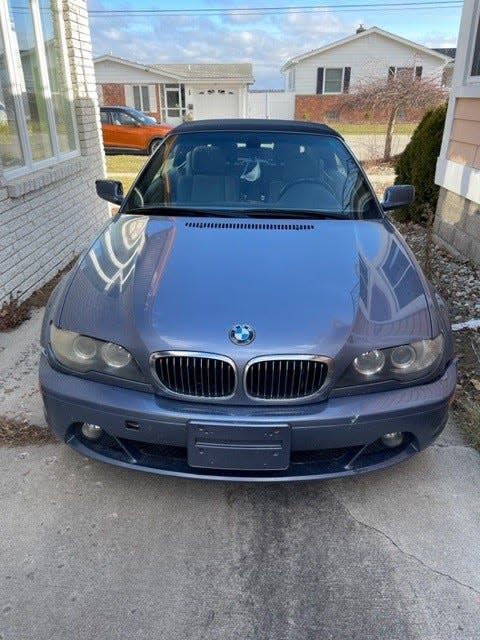 A 2004 BMW sitting in the driveway during an estate sale in Port Huron, priced at $3,000, on Jan. 6, 2023.