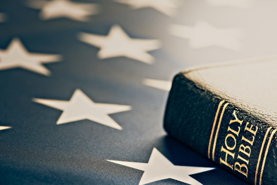 Bible next to a U.S. flag.