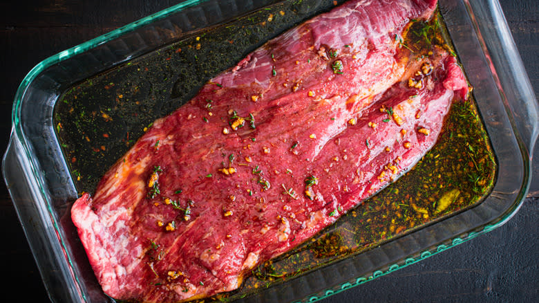 Steak marinading in glass pan