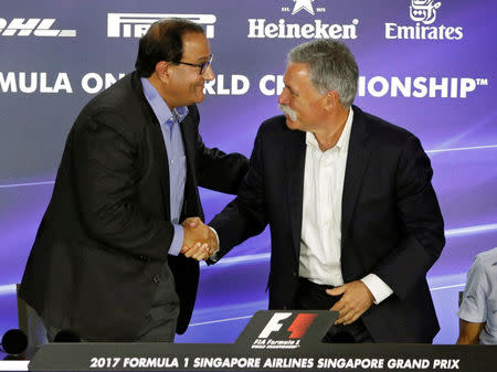 Formula One chief, Chase Carey, shakes hands with Singapore's Trade and Industry Minister S. Iswaran during a news conference at the Singapore F1 Grand Prix night race in Singapore September 15, 2017. REUTERS/Edgar Su