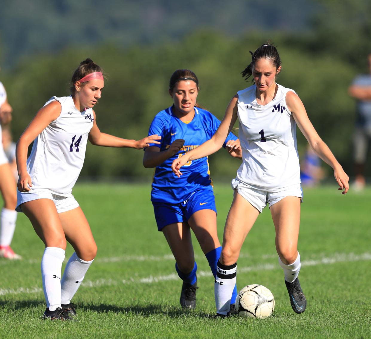 Monroe-Woodbury's Natalie Harwood gets the ball under control ahead of Washingtonville's Nicolette Mammoliti during Wednesday's game on August 30, 2023.