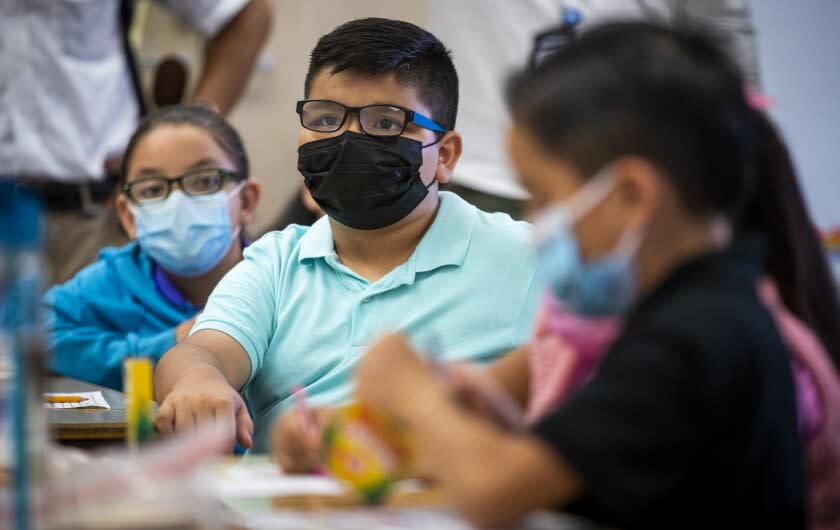 Los Angeles, CA - August 16: Third grade dual language students wear masks as they listen to instruction while Los Angeles Unified Interim Superintendent Megan K. Reilly, teachers, principals, school site employees visit on the first day of school at Los Angeles Unified School District at Montara Avenue Elementary School on Monday, Aug. 16, 2021 in Los Angeles, CA. Los Angeles Unified Interim Superintendent Megan K. Reilly, Board Members and special guests celebrate the first day of instruction on August 16, welcoming students, teachers, principals, school site employees and families, while visiting special programs and classrooms at each site. (Allen J. Schaben / Los Angeles Times)