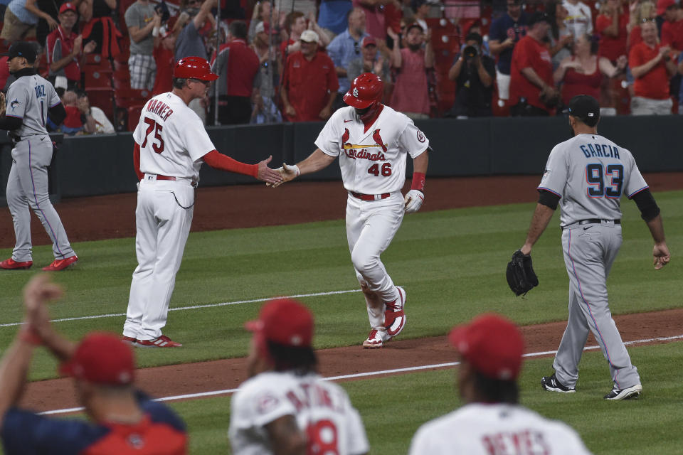 St. Louis Cardinals' Paul Goldschmidt (46) is congratulated by third base coach Ron "Pop" Warner after hitting a game-ending home run during the ninth inning of the tema's baseball game against the Miami Marlins on Tuesday, June 15, 2021, in St. Louis. (AP Photo/Joe Puetz)