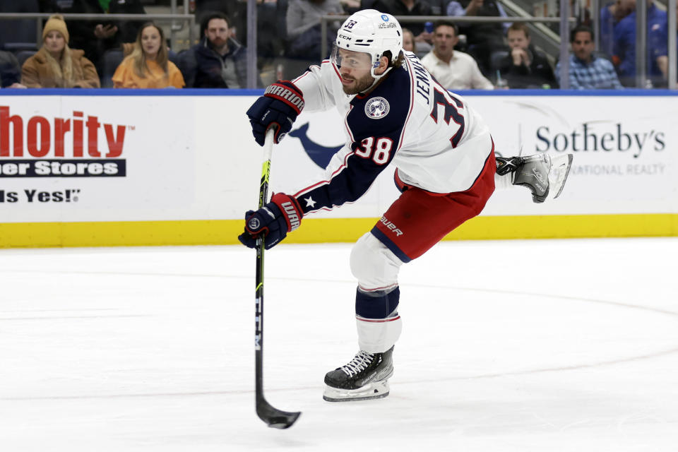 FILE - Columbus Blue Jackets center Boone Jenner (38) shoots against the New York Islanders in the first period of an NHL hockey game March 10, 2022, in Elmont, N.Y. The Blue Jackets pulled off the improbable, landing the hottest free agent on the market in winger Johnny Gaudreau. The question is who will center the top line with Gaudreau and Patrik Laine. Training camp will determine whether Jenner, Jack Roslovic or Cole Sillinger fit best with the pair. (AP Photo/Adam Hunger, File)