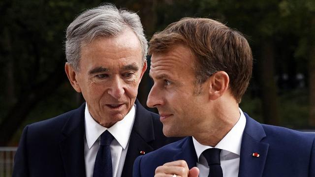 LVMH CEO Bernard Arnault and his wife arrive at the Elysee Palace