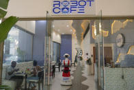 Robotic waiter serves customers at a Robot Cafe in Nairobi, Kenya Thursday, Aug. 29, 2024. The three robots, christened Claire, R24 and Nadia, are not programmed to have a full conversation with customers, but they can say "Your order is ready, Welcome" then people have to press an exit button after picking up their food from the tray. (AP Photo/Brian Inganga)