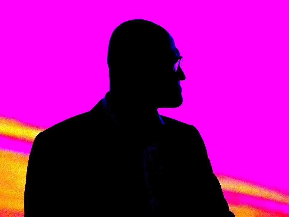 A silhouette of Microsoft CEO Satya Nadella against a pink backdrop.