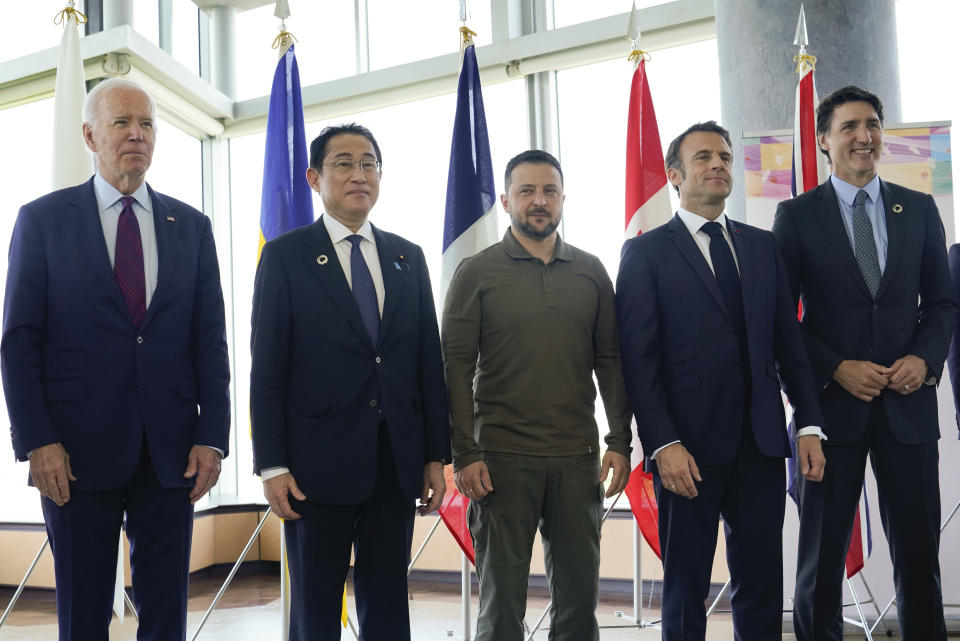 President Joe Biden, left, Japanese Prime Minister Fumio Kishida, Canadian Prime Minister Justin Trudeau, right, and French President Emmanuel Macron, second right, stand with Ukrainian President Volodymyr Zelenskyy pose for a photo before a working session on Ukraine during the G7 Summit in Hiroshima, Japan, Sunday, May 21, 2023. (AP Photo/Susan Walsh, POOL)