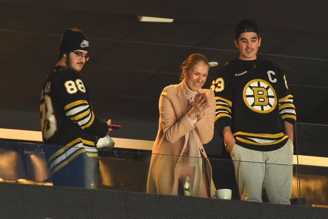 <p>Steve Babineau/NHLI via Getty</p> Celine Dion and her sons after the Boston Bruins game